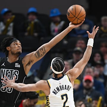 Mar 22, 2025; Indianapolis, Indiana, USA; Brooklyn Nets center Nic Claxton (33) and Indiana Pacers guard Andrew Nembhard (2) go after the ball during the first half at Gainbridge Fieldhouse. Mandatory Credit: Robert Goddin-Imagn Images