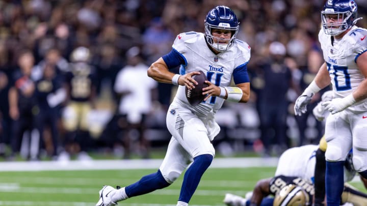 Aug 25, 2024; New Orleans, Louisiana, USA;  Tennessee Titans quarterback Mason Rudolph (11) scrambles out the pocket against the New Orleans Saints during the second half at Caesars Superdome. Mandatory Credit: Stephen Lew-USA TODAY Sports