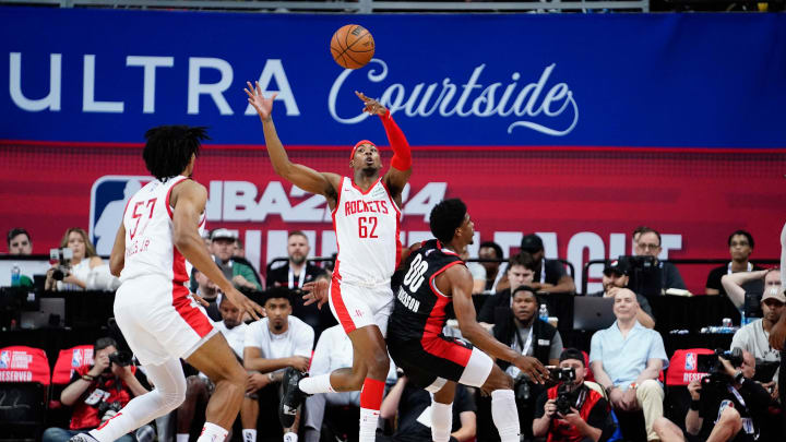 Jul 7, 2023; Las Vegas, NV, USA; Houston Rockets guard/forward Nate Hinton (62) keeps the ball in play against Portland Trail Blazers guard Scoot Henderson (00) during the first half at Thomas & Mack Center. Mandatory Credit: Lucas Peltier-USA TODAY Sports