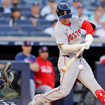 Sep 30, 2025; Bronx, New York, USA; Boston Red Sox third base Alex Bregman (2) hits a single during the first inning against the New York Yankees during game one of the Wildcard round for the 2025 MLB playoffs at Yankee Stadium. Mandatory Credit: Brad Penner-Imagn Images