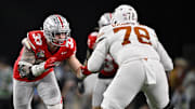 Jan 10, 2025; Arlington, TX, USA; Ohio State Buckeyes defensive end Jack Sawyer (33) rushes against Texas Longhorns offensive lineman Kelvin Banks Jr. (78) during the game at AT&T Stadium. Mandatory Credit: Jerome Miron-Imagn Images