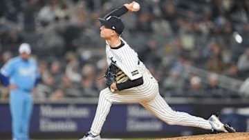 Apr 14, 2025; Bronx, New York, USA; New York Yankees pitcher Luke Weaver (30) delivers a pitch against the Kansas City Royals during the eighth inning at Yankee Stadium.