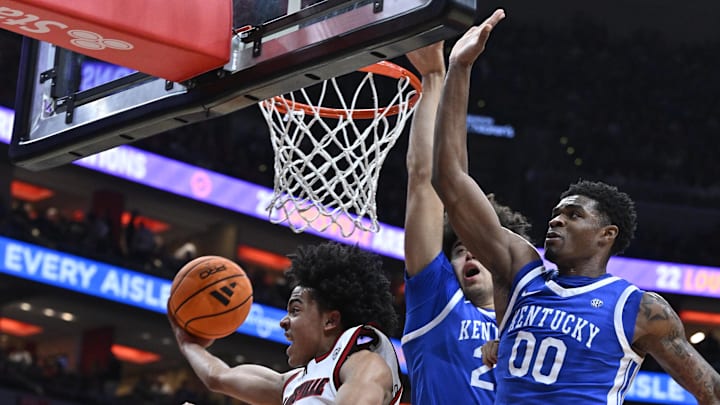 Nov 11, 2025; Louisville, Kentucky, USA;  Louisville Cardinals guard Mikel Brown Jr. (0) shoots against Kentucky Wildcats guard Otega Oweh (00) and center Malachi Moreno (24) during the second half at KFC Yum! Center. Louisville defeated Kentucky 96-88. Mandatory Credit: Jamie Rhodes-Imagn Images