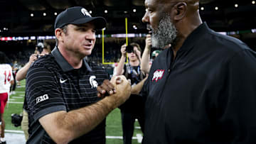 Nov 29, 2025; Detroit, Michigan, USA; Michigan State head coach Jonathan Smith shakes hands with Maryland head coach Mike Locksley after Michigan State defeated Maryland at Ford Field. Mandatory Credit: Brendan Mullin-Imagn Images