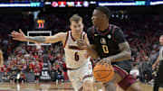 Feb 22, 2025; Louisville, Kentucky, USA;  Florida State Seminoles guard Chandler Jackson (0) drives to the basket against Louisville Cardinals guard Reyne Smith (6) during the first half at KFC Yum! Center. Mandatory Credit: Jamie Rhodes-Imagn Images