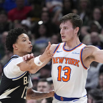 New York Knicks guard Tyler Kolek looks for an outlet against Milwaukee Bucks guard Ryan Rollins. Mandatory Credit: Michael McLoone-Imagn Images