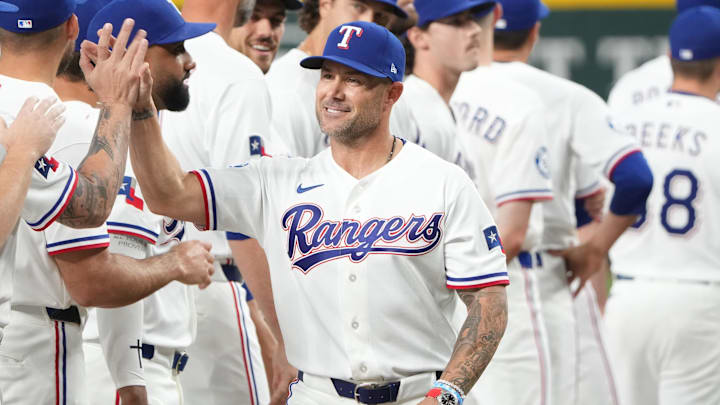 Apr 3, 2026; Arlington, Texas, USA; Texas Rangers manager Skip Schumaker greets teammates during opening week ceremonies before the game against the Cincinnati Reds at Globe Life Field. Mandatory Credit: Jim Cowsert-Imagn Images