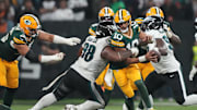Green Bay Packers quarterback Jordan Love (10) is hit by Philadelphia Eagles defensive tackle Jalen Carter (98) on Friday.