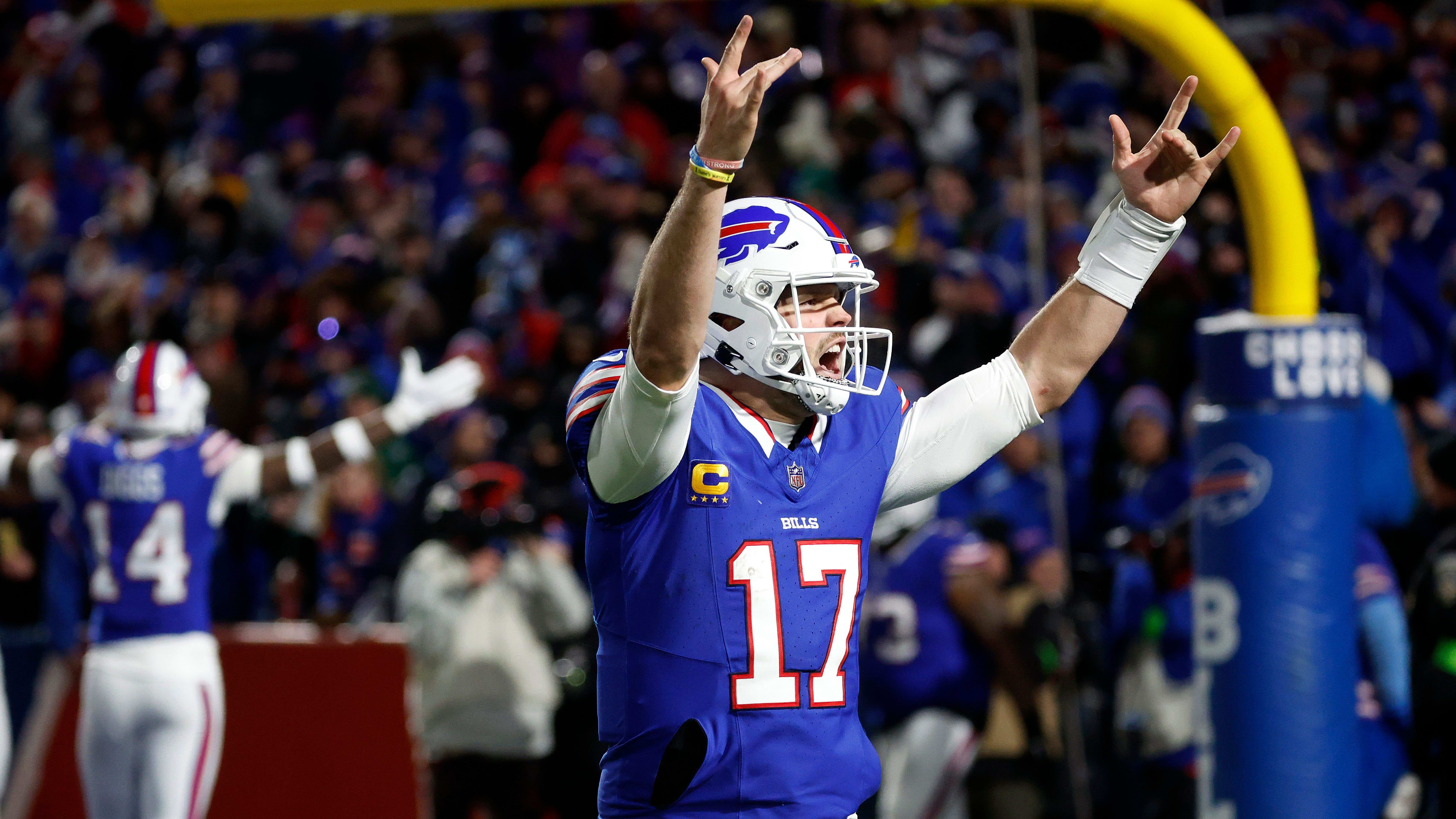 Buffalo Bills quarterback Josh Allen (17) celebrates with fans after his 81 yard touchdown pass to