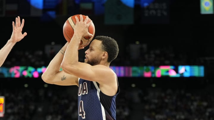 Aug 6, 2024; Paris, France; United States guard Stephen Curry (4) shoot against Brazil in the first half in a men’s basketball quarterfinal game during the Paris 2024 Olympic Summer Games at Accor Arena. 