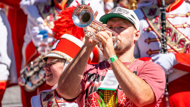 Former Nebraska Cornhuskers linebacker and NFL free agent Will Compton holds a trumpet with the Cornhusker Marching Band