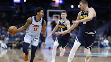 Dec 7, 2024; Washington, District of Columbia, USA; Washington Wizards guard Jordan Poole (13) dribbles the ball as Denver Nuggets center Nikola Jokic (15) and Nuggets guard Christian Braun (0) defend in the third quarter at Capital One Arena. Mandatory Credit: Geoff Burke-Imagn Images