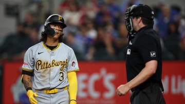Aug 19, 2024; Arlington, Texas, USA; Pittsburgh Pirates center fielder Ji Hwan Bae (3) peititions home plate umpire John Bacon (70) after being called out on strikes in the fourth inning against the Texas Rangers at Globe Life Field. Mandatory Credit: Tim Heitman-USA TODAY Sports