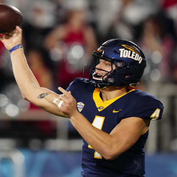 Dec 20, 2022; Boca Raton, Florida, USA; Toledo Rockets quarterback Tucker Gleason (4) throws a pass against the Liberty Flames during the second quarter in the 2022 Boca Raton Bowl at FAU Stadium. Mandatory Credit: Rich Storry-USA TODAY Sports