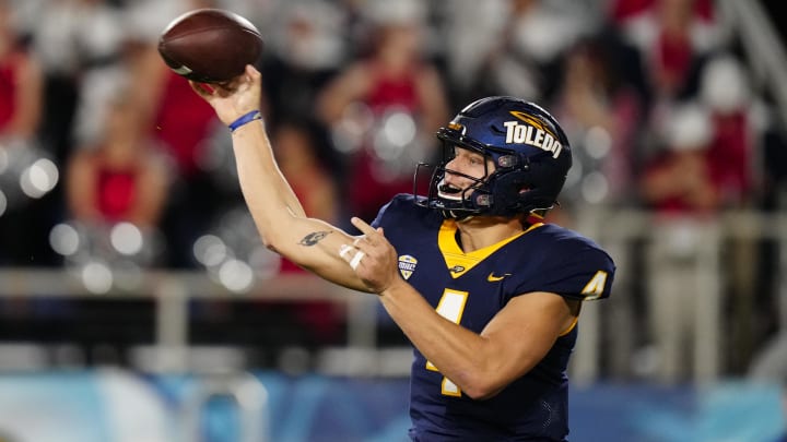 Dec 20, 2022; Boca Raton, Florida, USA; Toledo Rockets quarterback Tucker Gleason (4) throws a pass against the Liberty Flames during the second quarter in the 2022 Boca Raton Bowl at FAU Stadium. Mandatory Credit: Rich Storry-USA TODAY Sports