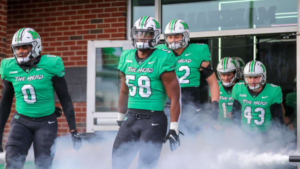 Marshall Thundering Herd defensive lineman Elijah Alston (58) runs onto the field prior to their game against the Western Ken