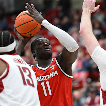 Arizona Wildcats center Oumar Ballo (11) shoots the ball against Washington State Cougars forward Oscar Cluff (45) in the first half at Friel Court at Beasley Coliseum.