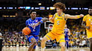 Dec 8, 2024; Columbia, Missouri, USA; Kansas Jayhawks guard AJ Storr (2) drives against Missouri Tigers guard T.O. Barrett (5) during the second half at Mizzou Arena. Mandatory Credit: Jay Biggerstaff-Imagn Images