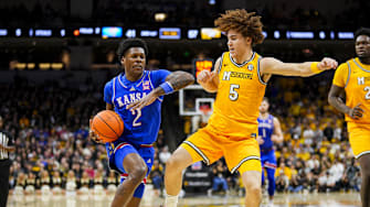 Dec 8, 2024; Columbia, Missouri, USA; Kansas Jayhawks guard AJ Storr (2) drives against Missouri Tigers guard T.O. Barrett (5) during the second half at Mizzou Arena. Mandatory Credit: Jay Biggerstaff-Imagn Images