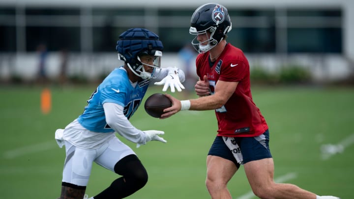 Tennessee Titans quarterback Will Levis (8) hands off to running back Tony Pollard (20) on the first day of training camp at Ascension Saint Thomas Sports Park Wednesday, July 24, 2024.