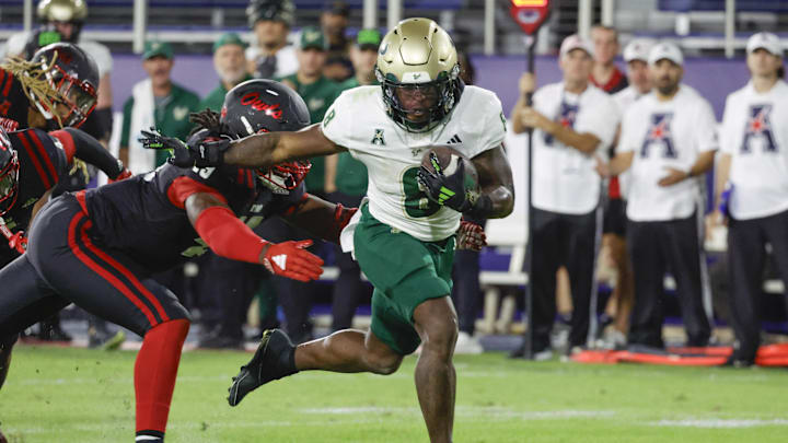 South Florida Bulls running back Kelley Joiner (8) gets past Florida Atlantic Owls defensive end Chris Jones (49) during the second half at FAU Stadium. South Florida Bulls running back Kelley Joiner (8) gets past Florida Atlantic Owls defensive end Chris Jones (49) during the second half at FAU Stadium.