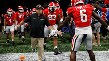 Georgia coach Kirby Smart leads his team onto the field for warm ups before the start of the NCAA Aflac Kickoff Game in Atlanta, on Saturday, Aug. 31, 2024.