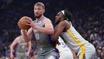 Apr 26, 2023; Sacramento, California, USA; Sacramento Kings forward Domantas Sabonis (10) spins towards the hoop next to Golden State Warriors forward Kevon Looney (5) in the first quarter during game five of the 2023 NBA playoffs at the Golden 1 Center. Mandatory Credit: Cary Edmondson-Imagn Images