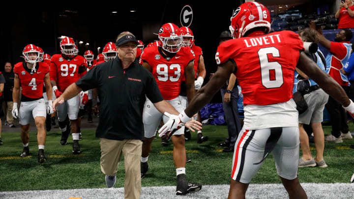 Georgia coach Kirby Smart leads his team onto the field for warm ups before the start of the NCAA Aflac Kickoff Game in Atlanta, on Saturday, Aug. 31, 2024.