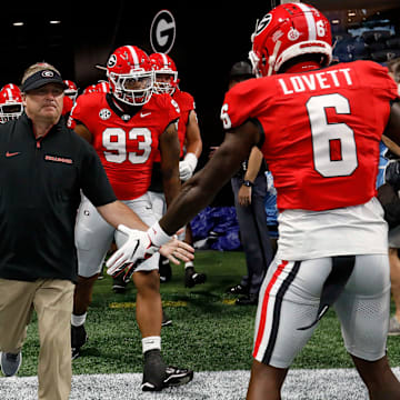 Georgia coach Kirby Smart leads his team onto the field for warm ups before the start of the NCAA Aflac Kickoff Game in Atlanta, on Saturday, Aug. 31, 2024.