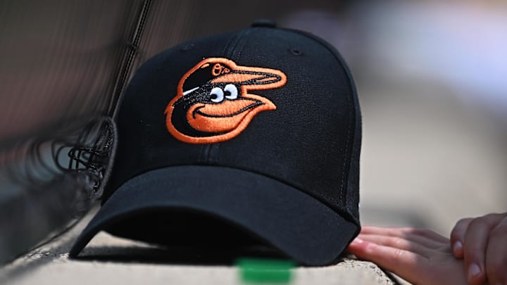 Jul 31, 2024; Baltimore, Maryland, USA; A Baltimore Orioles baseball cap of a fan before the game between the Baltimore Orioles and the Toronto Blue Jays at Oriole Park at Camden Yards. 