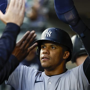 New York Yankees right fielder Juan Soto (22) high-fives teammates in the dugout after during the first inning at T-Mobile Park on Sept 17.