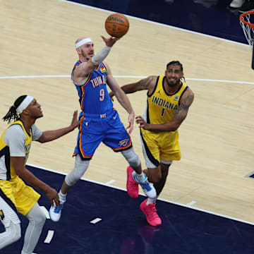 Jun 13, 2025; Indianapolis, Indiana, USA; Oklahoma City Thunder guard Alex Caruso (9) drives to the hoop past Indiana Pacers forward Obi Toppin (1) and center Myles Turner (33) during the third quarter of game four of the 2025 NBA Finals at Gainbridge Fieldhouse. Mandatory Credit: Trevor Ruszkowski-Imagn Images