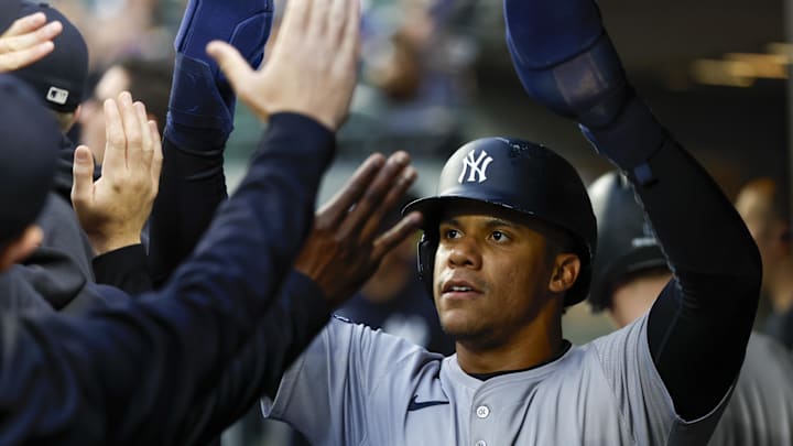 New York Yankees right fielder Juan Soto (22) high-fives teammates in the dugout after during the first inning at T-Mobile Park on Sept 17.