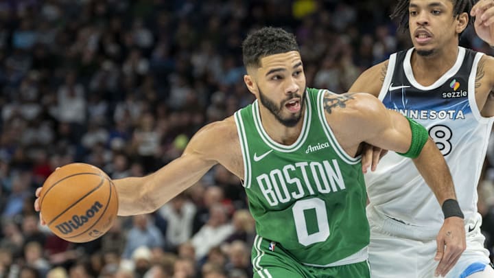 Jan 2, 2025; Minneapolis, Minnesota, USA; Boston Celtics forward Jayson Tatum (0) drives past Minnesota Timberwolves forward Josh Minott (8) in the first half at Target Center. Mandatory Credit: Jesse Johnson-Imagn Images