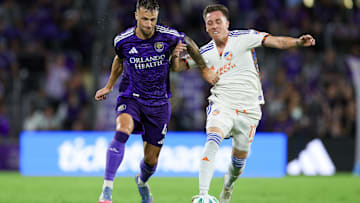 Jun 28, 2025; Orlando, Florida, USA; Orlando City defender David Brekalo (4) and FC Cincinnati forward Corey Baird (11) battle for the ball in the second half at Inter&Co Stadium. Mandatory Credit: Nathan Ray Seebeck-Imagn Images