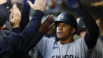 Sep 17, 2024; Seattle, Washington, USA; New York Yankees right fielder Juan Soto (22) high-fives teammates in the dugout after during the first inning at T-Mobile Park. Mandatory Credit: Joe Nicholson-Imagn Images