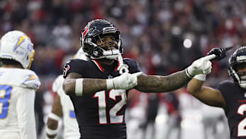 Jan 11, 2025; Houston, Texas, USA;  Houston Texans wide receiver Nico Collins (12) reacts to a first down against the Los Angeles Chargers in the second quarter in an AFC wild card game at NRG Stadium. Mandatory Credit: Thomas Shea-Imagn Images