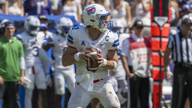 SMU Mustangs quarterback Preston Stone attempts a pass during a college football game.