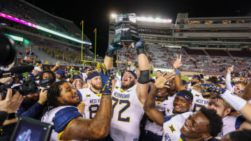 WVU celebrates a win over rival Virginia Tech, who was the victim of an upset Saturday.