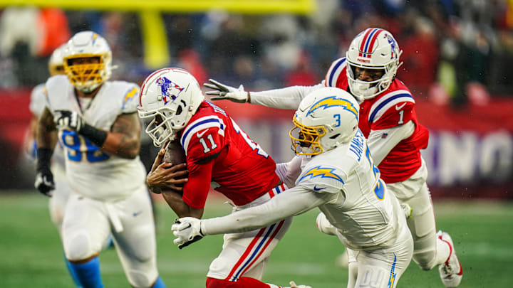 Dec 3, 2023; Foxborough, Massachusetts, USA; New England Patriots wide receiver Tyquan Thornton (11) runs the ball against Los Angeles Chargers safety Derwin James Jr. (3) in the second half at Gillette Stadium. Mandatory Credit: David Butler II-Imagn Images