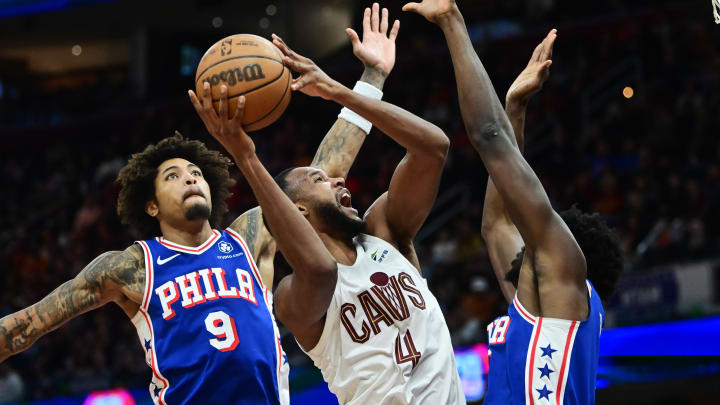 Mar 29, 2024; Cleveland, Ohio, USA; Cleveland Cavaliers forward Evan Mobley (4) drives to the basket between Philadelphia 76ers guard Kelly Oubre Jr. (9) and center Mo Bamba (5) during the second half at Rocket Mortgage FieldHouse. Mandatory Credit: Ken Blaze-USA TODAY Sports