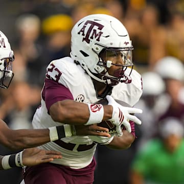 Nov 8, 2025; Columbia, Missouri, USA; Texas A&M Aggies running back Jamarion Morrow (23) takes the handoff from quarterback Marcel Reed (10) during the first half against the Missouri Tigers at Faurot Field at Memorial Stadium. Mandatory Credit: Jay Biggerstaff-Imagn Images