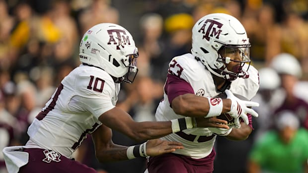 Texas A&M Aggies running back Jamarion Morrow (23) takes the handoff from quarterback Marcel Reed (10).