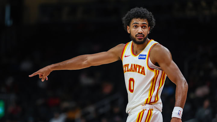 Hawks forward Jacob Toppin (0) points while talking to a teammate during a game against the Miami Heat. 