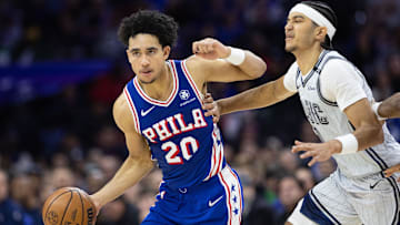 Dec 4, 2024; Philadelphia, Pennsylvania, USA; Philadelphia 76ers guard Jared McCain (20) dribbles past Orlando Magic guard Anthony Black (0) during the fourth quarter at Wells Fargo Center. Mandatory Credit: Bill Streicher-Imagn Images