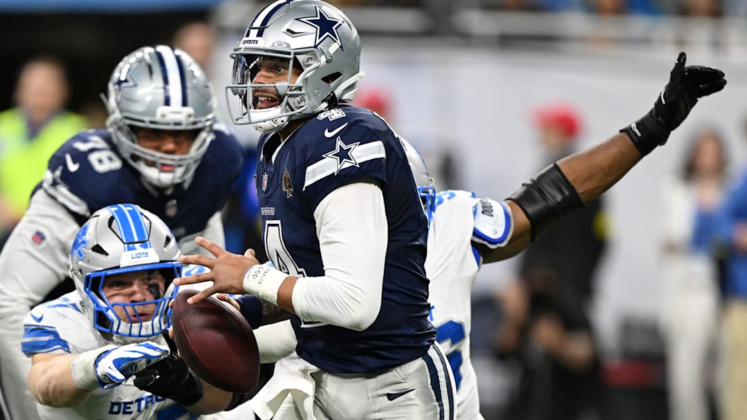 Dallas Cowboys quarterback Dak Prescott is pressured by Detroit Lions Al-Quadin Muhammad and Aidan Hutchinson. Dallas Cowboys quarterback Dak Prescott is pressured by Detroit Lions Al-Quadin Muhammad and Aidan Hutchinson.