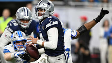 Dallas Cowboys quarterback Dak Prescott is pressured by Detroit Lions Al-Quadin Muhammad and Aidan Hutchinson.