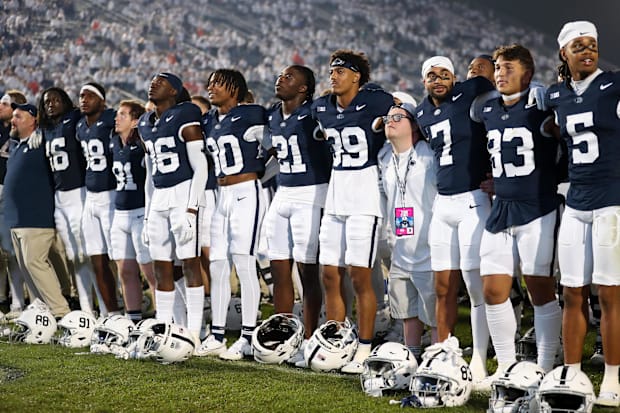 Penn State Nittany Lion players sing their alma-mater following a game against the Illinois Fighting Illini at Beaver Stadium