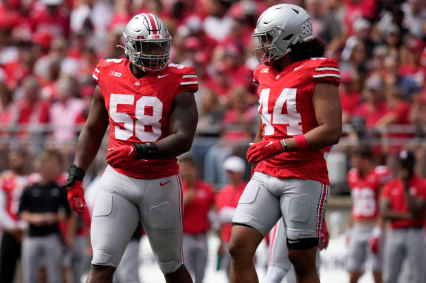 Football teammates walk next to each other.