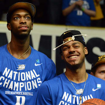 Duke Blue Devils players Amile Jefferson (left) and Quinn Cook react during a welcome home ceremony at Cameron Indoor Stadium.